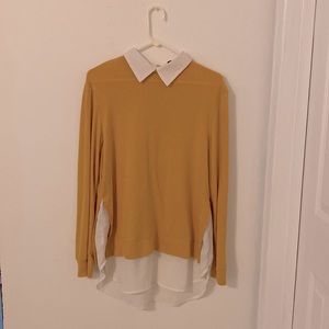 Yellow long sleeved shirt.